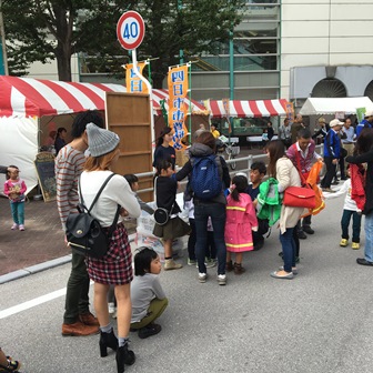 子ども防火服に並ぶ住民